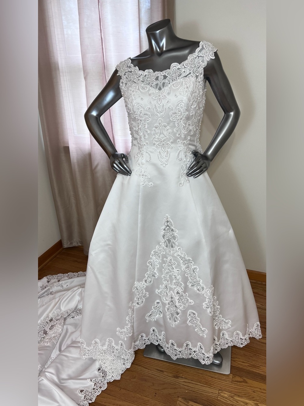 Elegant white vintage Michaelangelo wedding gown with cathedral length train.